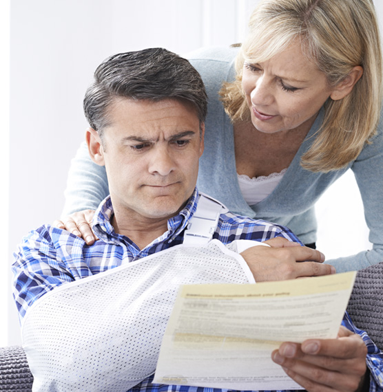 Husband looking over claims paperwork
