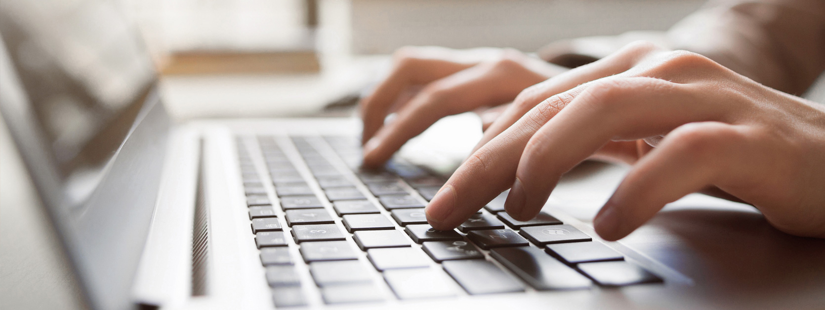 hands typing on laptop