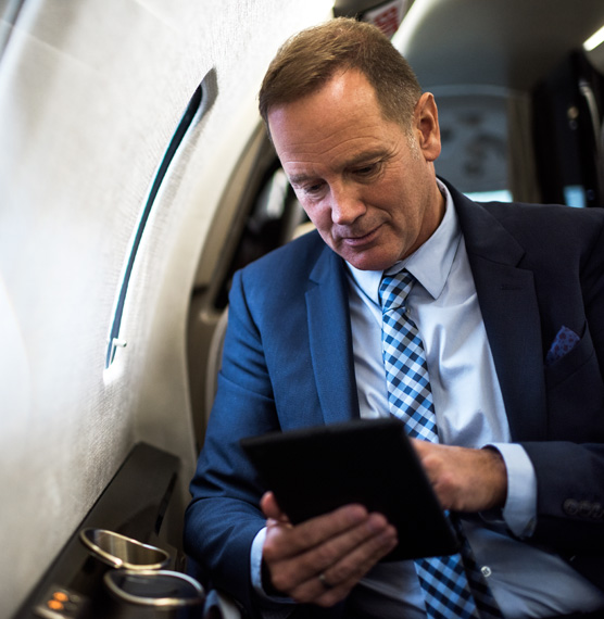 Man inside plane checking itinerary