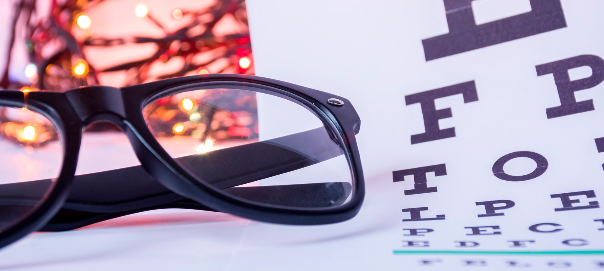 Eyeglasses laying on Snellen Chart