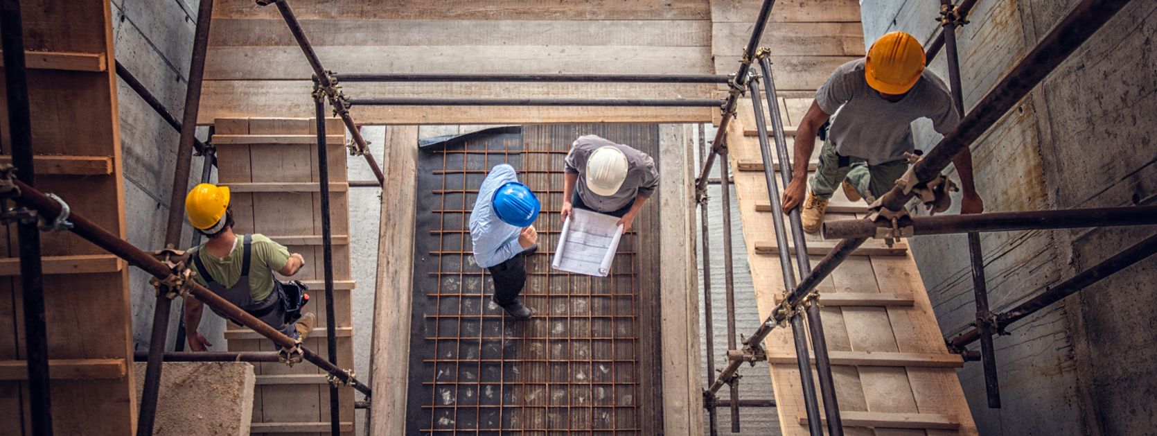 Inspecting construction plans, viewed from above.