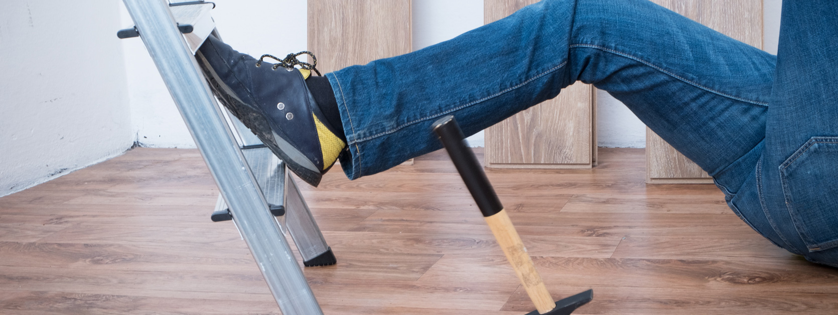Man falling off ladder, bottom of ladder and part of lower body showing